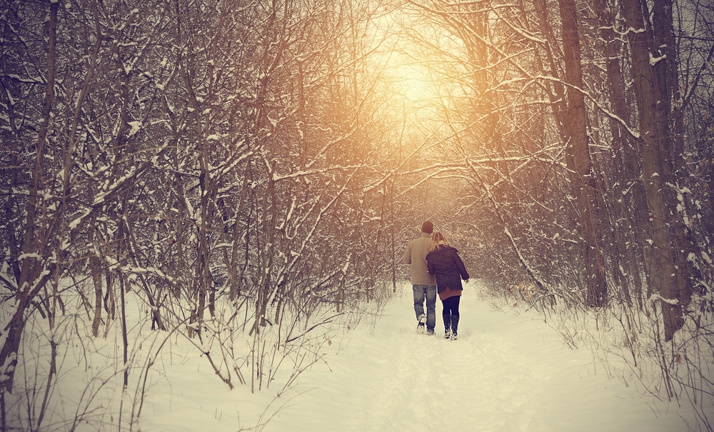 Romantic Getaway in Maryland, couple bundled up on a winter hike in Deep Creek Lake 