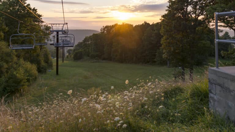 Brilliant sunset, chairlift at Wisp Resort. Take the chair lift up and down the mountain in the summer to have an aerial adventure.