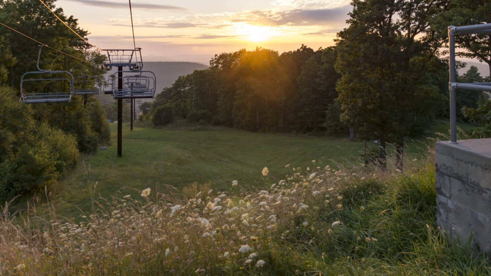 Brilliant sunset, chairlift at Wisp Resort. Take the chair lift up and down the mountain in the summer to have an aerial adventure.